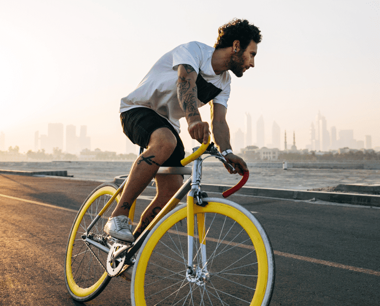 Man riding bike after physical therapy graduation
